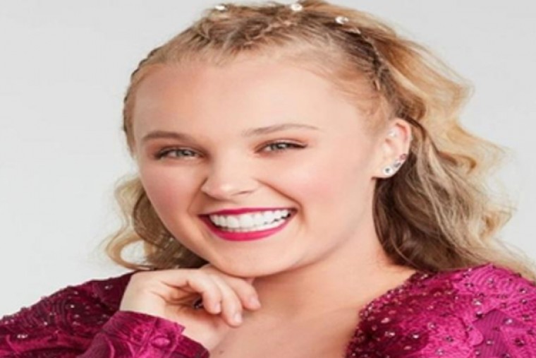 Chris Hughes gifts JoJo Siwa a bouquet of flowers at airport