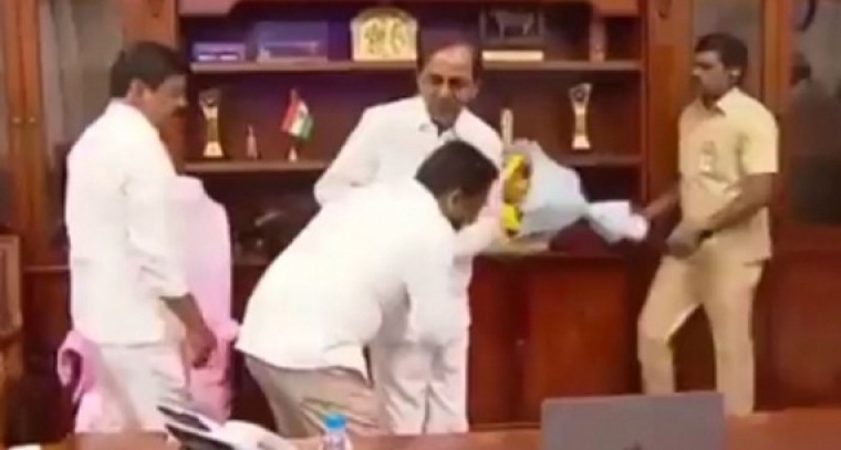 Dr G. Srinivasa Rao triggered a row by touching the feet of  CM KCR